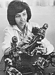 Pauline McCoskey at working making one of her papier-mâché dolls.